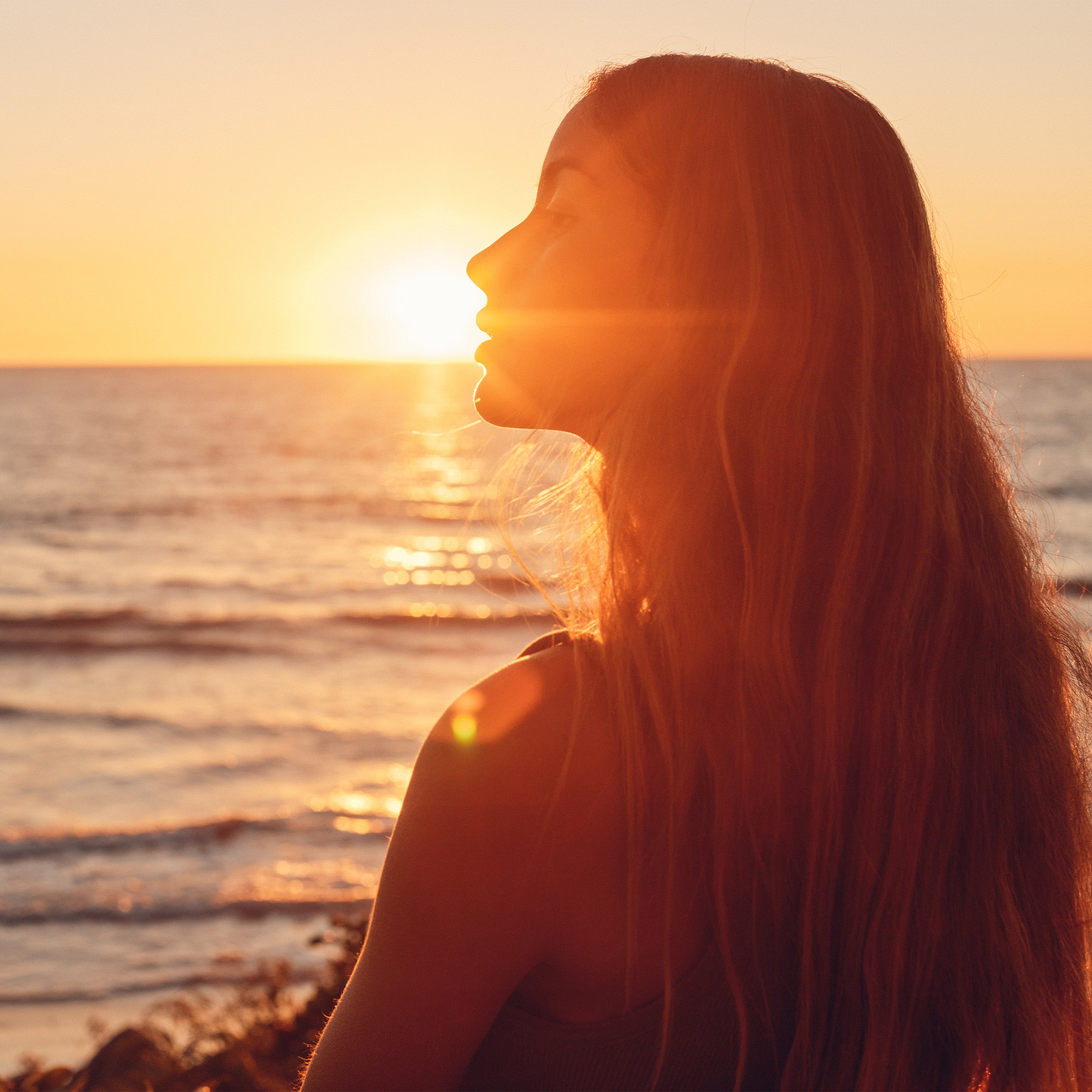 Golden hour glow shines on a peaceful beach moment, perfect for post-sun care and recovery – After Sun Collection - Sun Bum