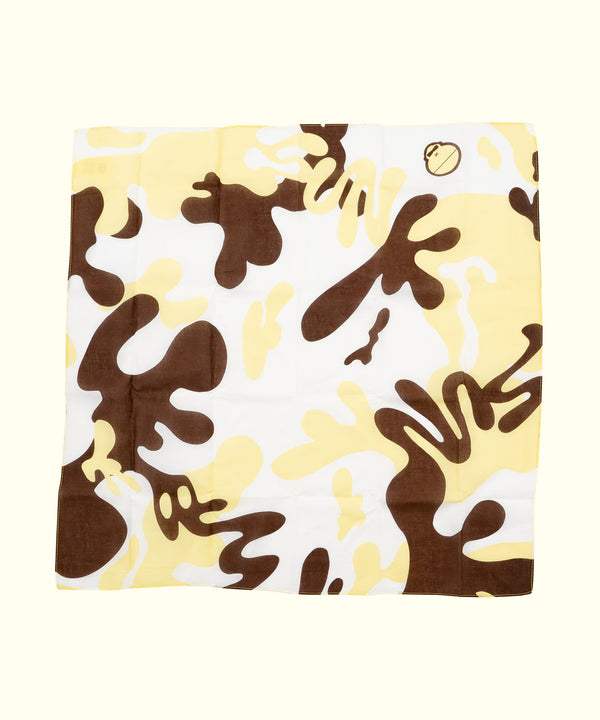 Yellow and brown camouflage bandana, versatile for dust protection, festival style, and everyday wear. Sun Bum.