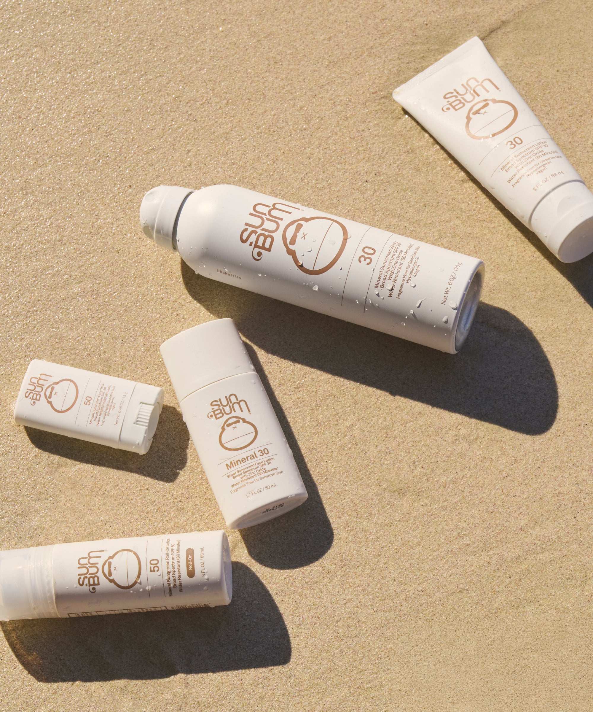 Mineral SPF 30 Liquid Face sunscreen on sand, lightweight and water-resistant protection by Sun Bum