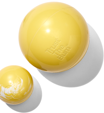 Two yellow balls with 'Trust the Bum' branding on a white background