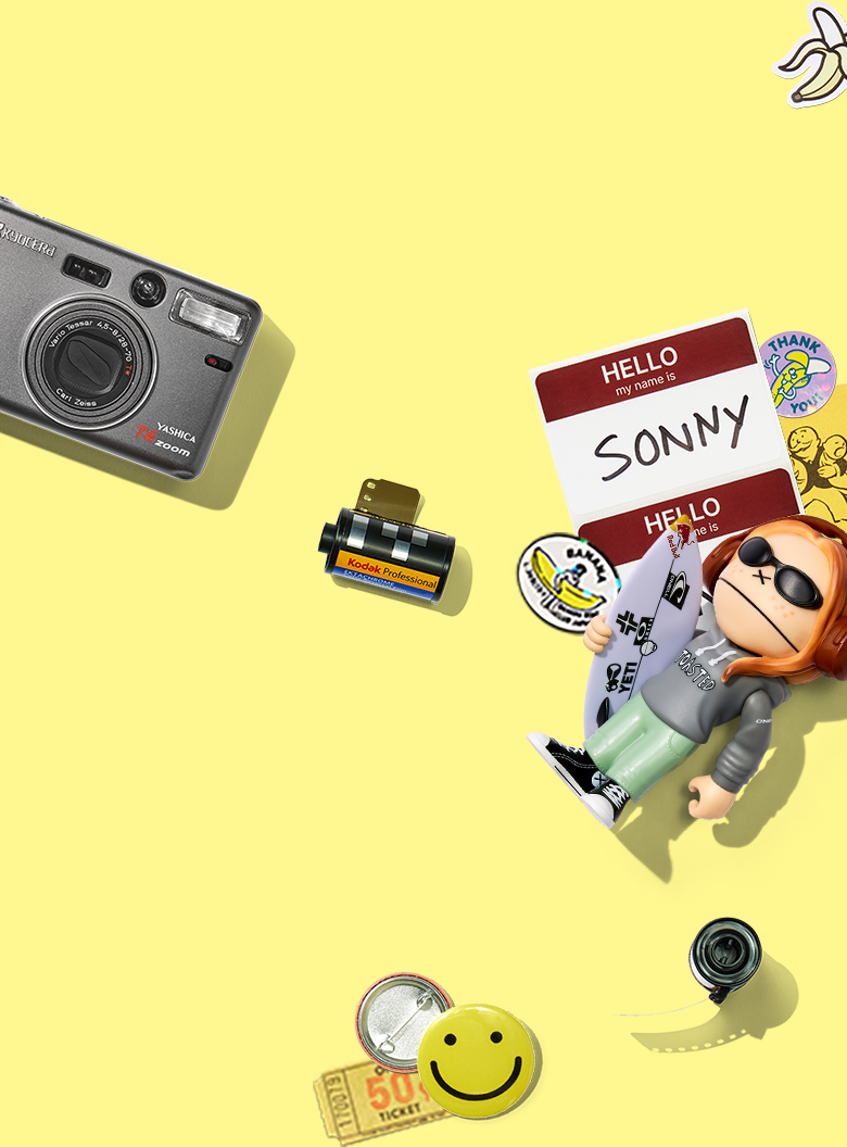 Camera accessories and figurine on a yellow background