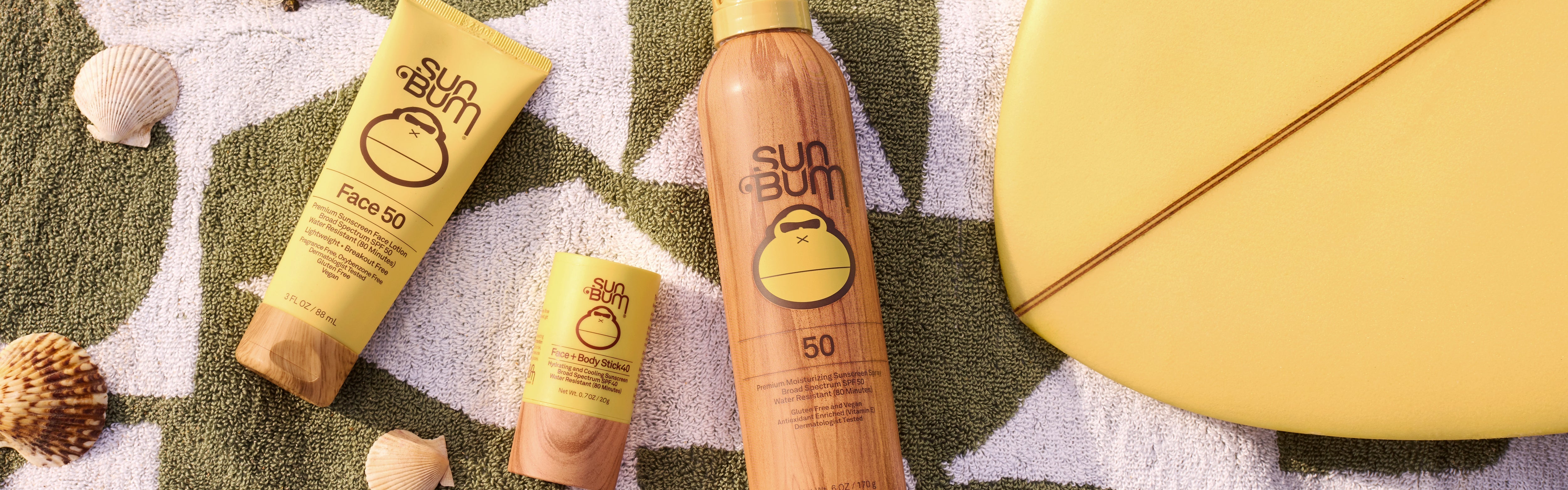 Sun Bum sunscreen essentials for face and body on a beach towel, from the Head to Toe Collection – Sun Bum.