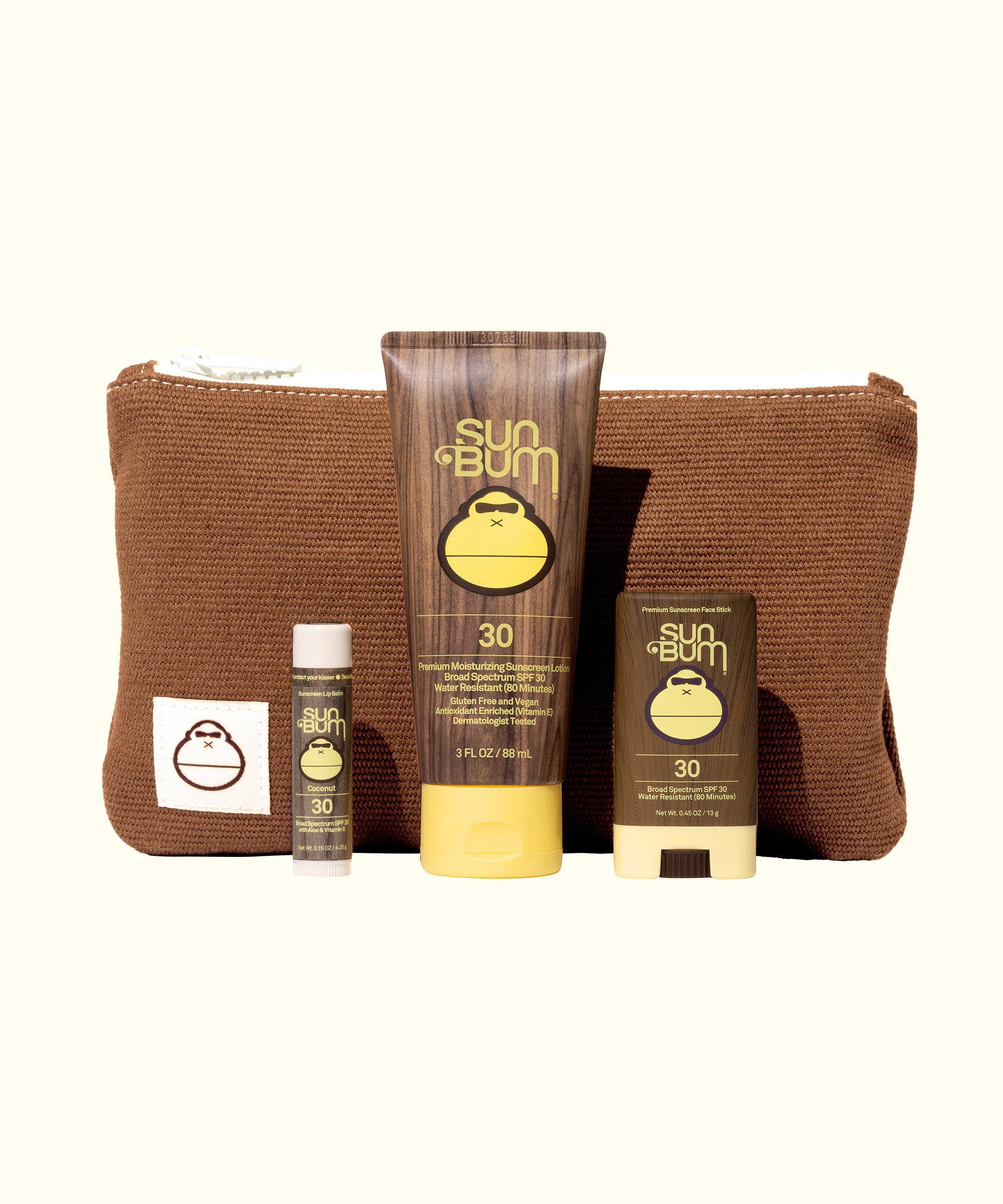 Road Tripper travel kit with SPF 30 sunscreen, lip balm and face stick in brown corduroy bag by Sun Bum
