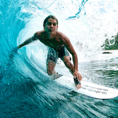 Person surfing on a wave with a surfboard