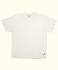 Original Tee (Cream), a 100% cotton short sleeve shirt laid flat with a small logo patch