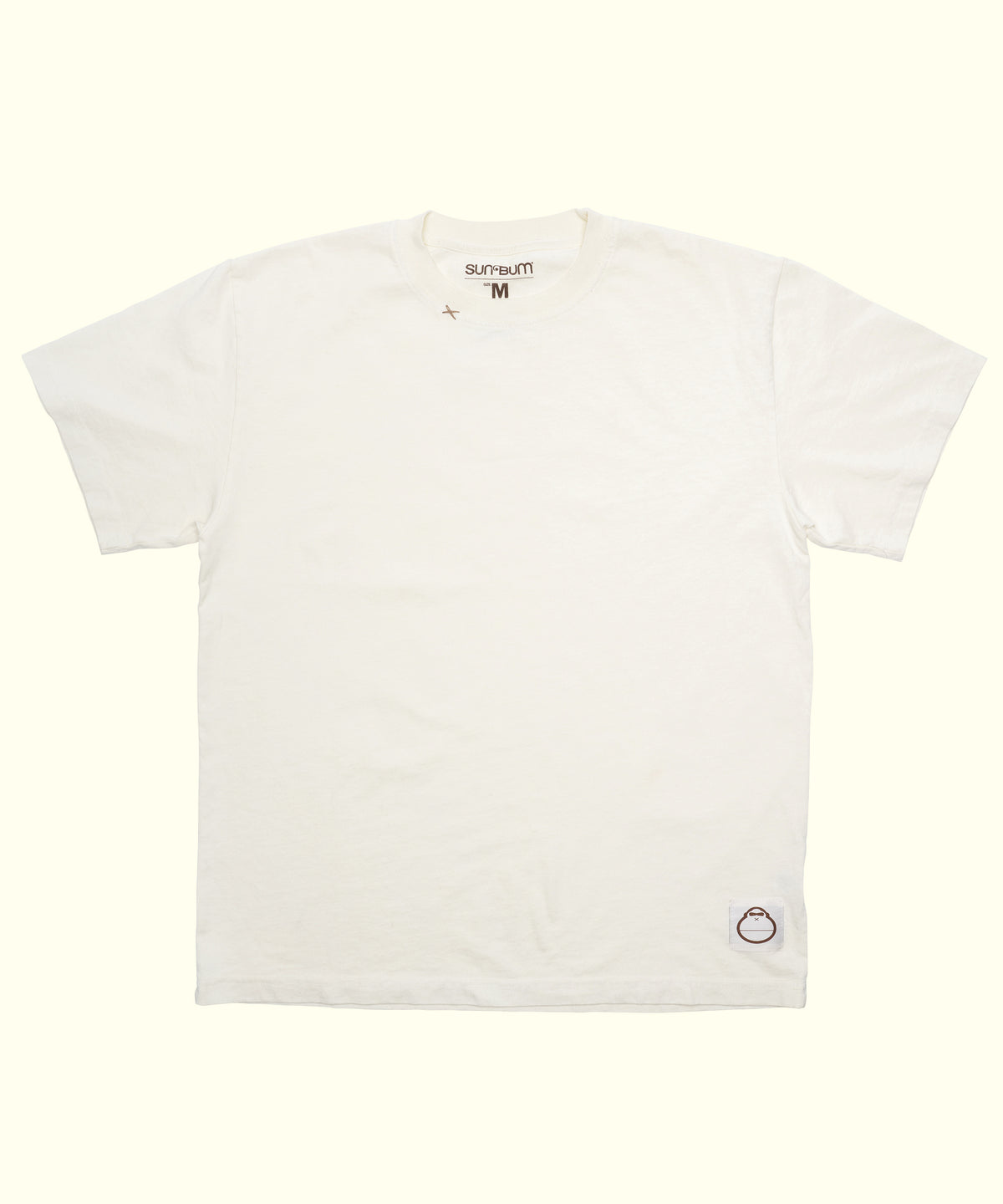 Original Tee (Cream), a 100% cotton short sleeve shirt laid flat with a small logo patch