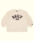 An off-white crewneck sweatshirt featuring a dark brown graphic on the chest that reads 'DAILY SPF' with 'SPF' inside an oval. A small brand tag is visible on the left sleeve cuff, and the inner collar shows the brand name 'DAILY'.