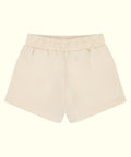A pair of cream-colored cotton shorts with an elastic waistband, shown flat against a solid cream background.