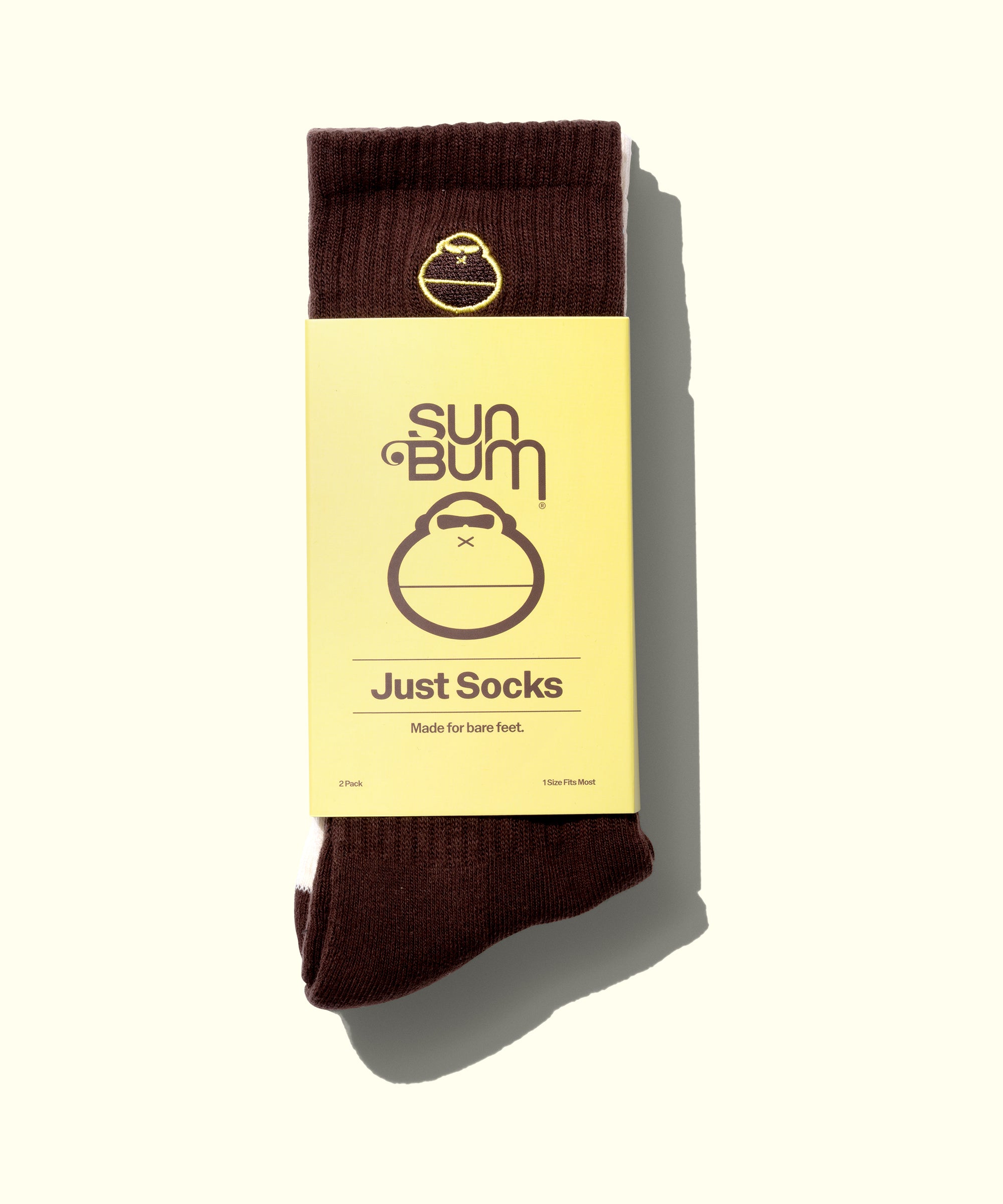 Brown sock with yellow Sun Bum label on a white background