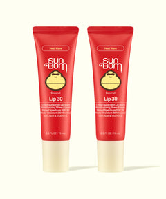 Two Sun Bum Heat Wave tinted lip balms in red tubes with beige caps shown side by side for Tinted Lip Duos.