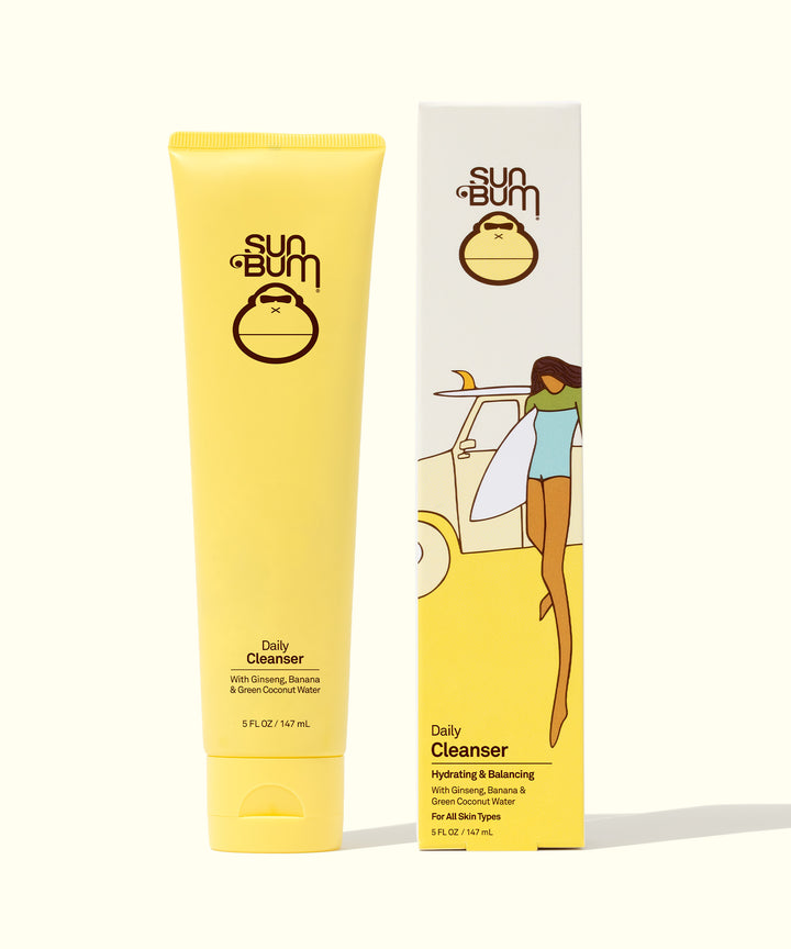 Yellow tube and box of Sun Bum Daily Cleanser, infused with Ginseng, Green Coconut Water, and Banana for gentle and hydrating skin cleansing, Sun Bum.