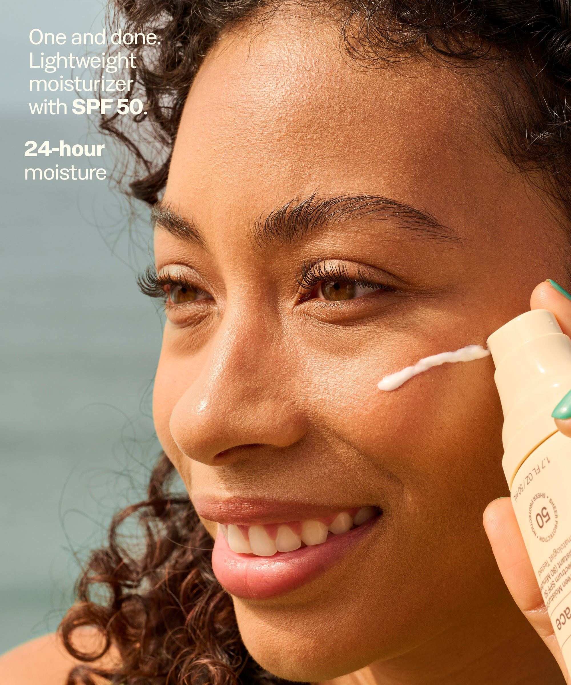 Person applying sunscreen to their face with a bottle labeled 'One and done. Lightweight moisturizer with SPF 50.'