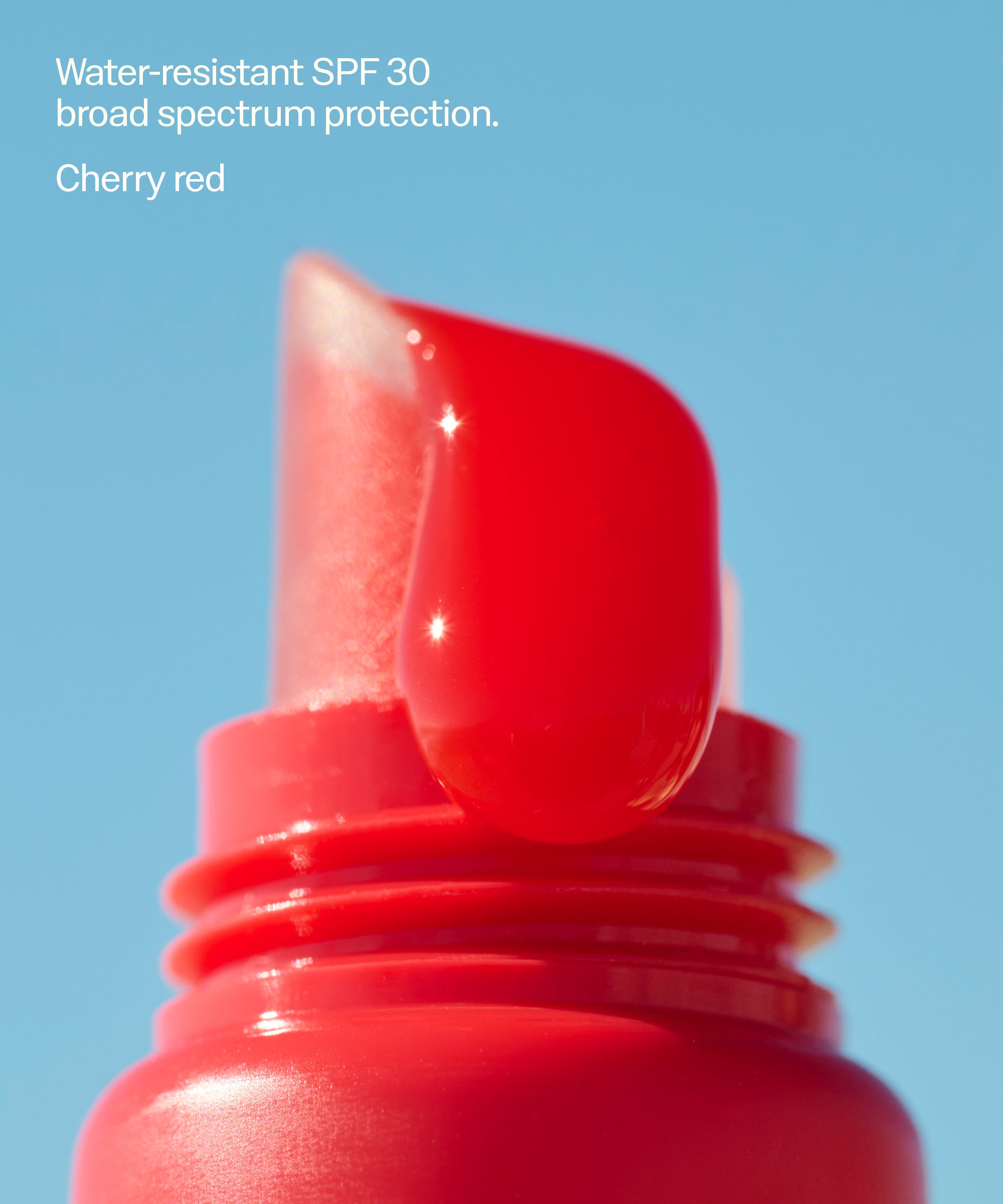 Close-up of Sun Bum Heat Wave SPF 30 Moisturizing Lip Balm in cherry red with water-resistant shine. Water-resistant SPF 30 broad spectrum protection.
Cherry red