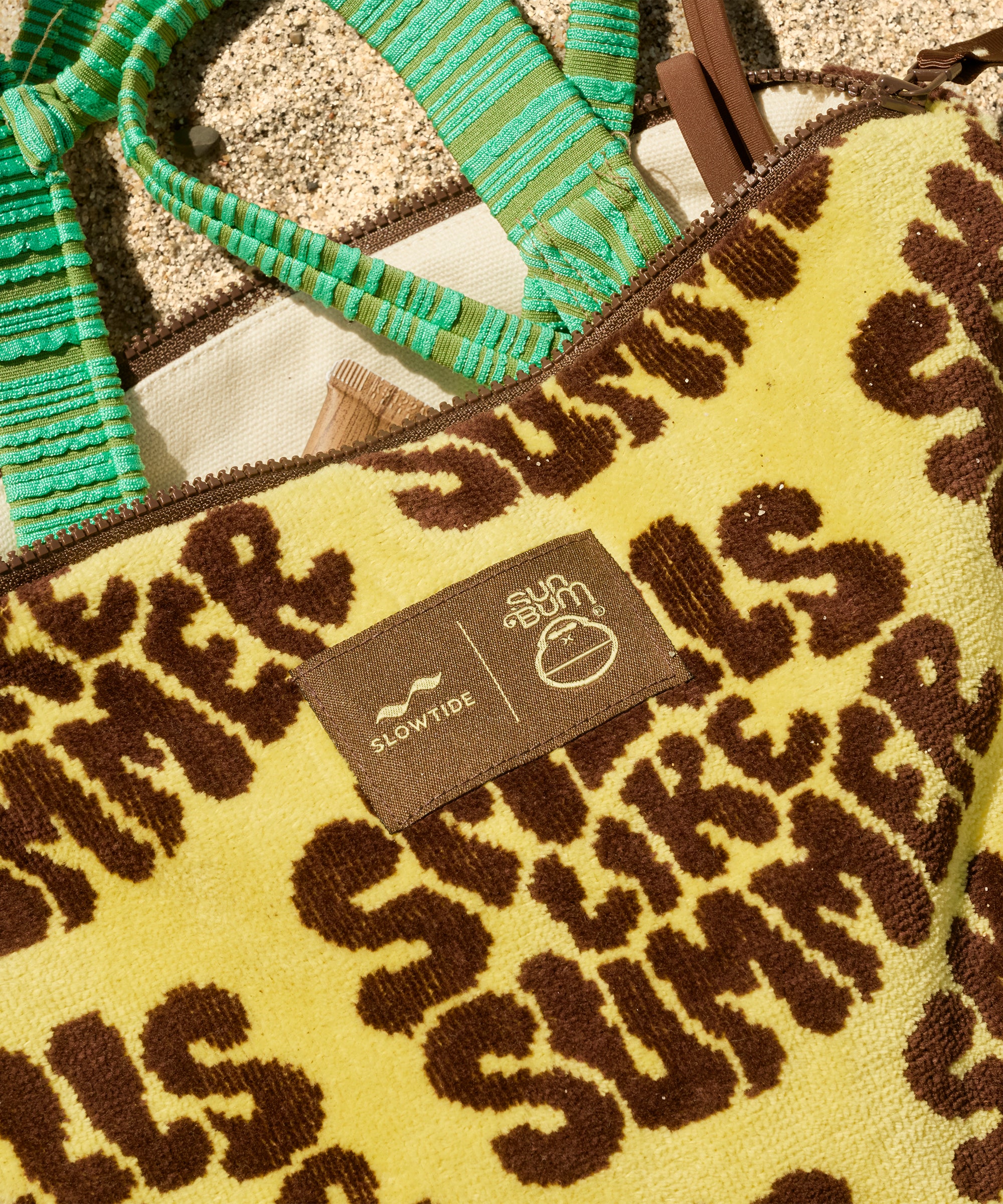 Close-up of a leopard print bag with 'SLOW SUMMER' branding.