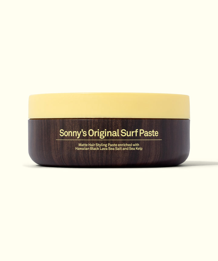 Image of Sonny's Original Surf Paste in a sleek, round container with a yellow lid, perfect for short hair to achieve a stylish look effortlessly. Sun Bum.
