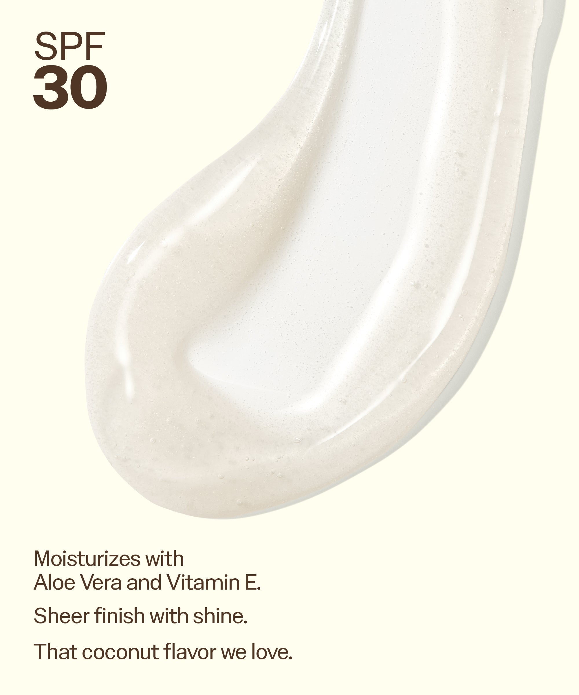 Close-up of a white cosmetic product with text about SPF 30, Aloe Vera, Vitamin E, and coconut flavor.