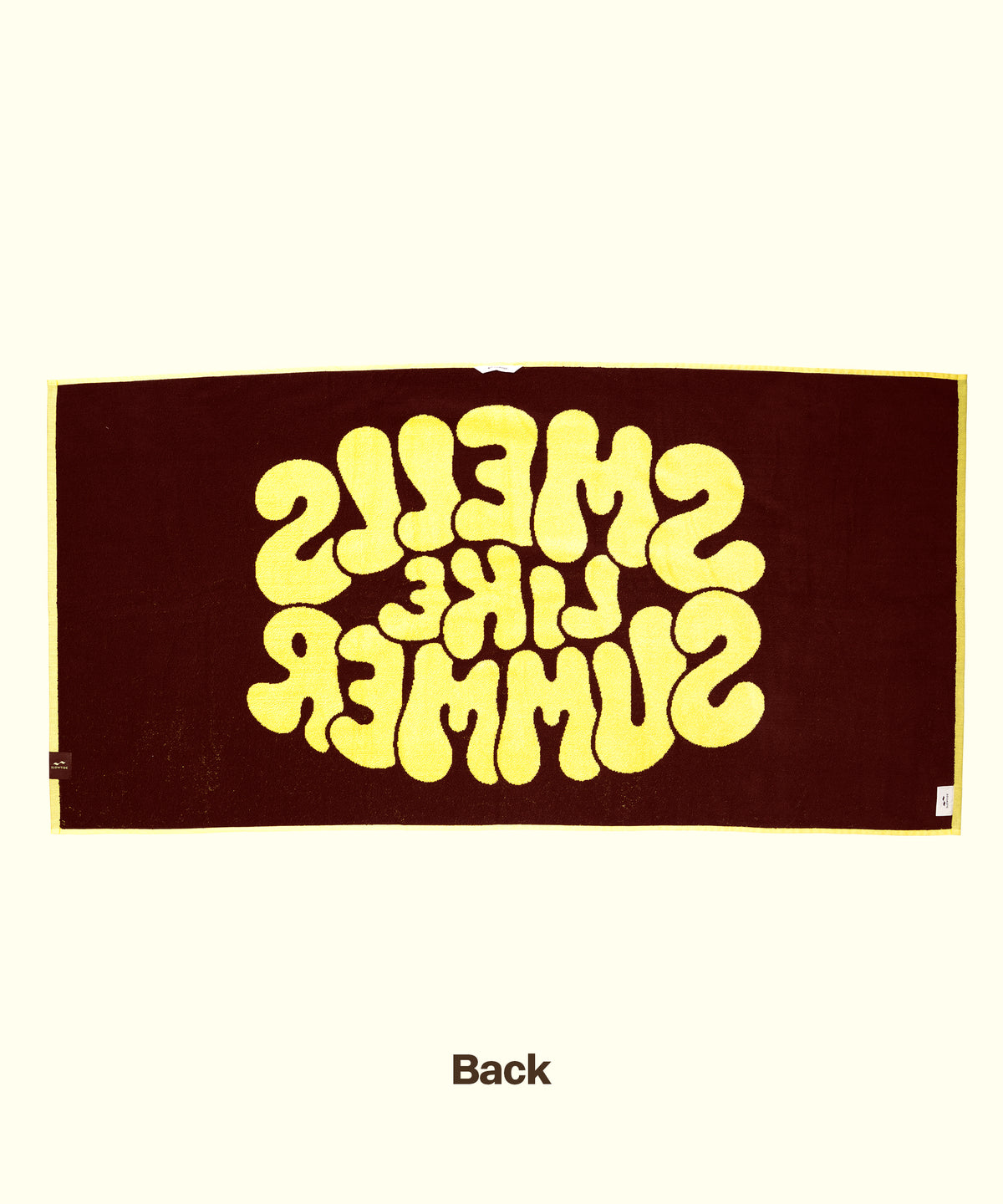 Textile product with 'SMELLS LIKE SUMMER' print on a brown background