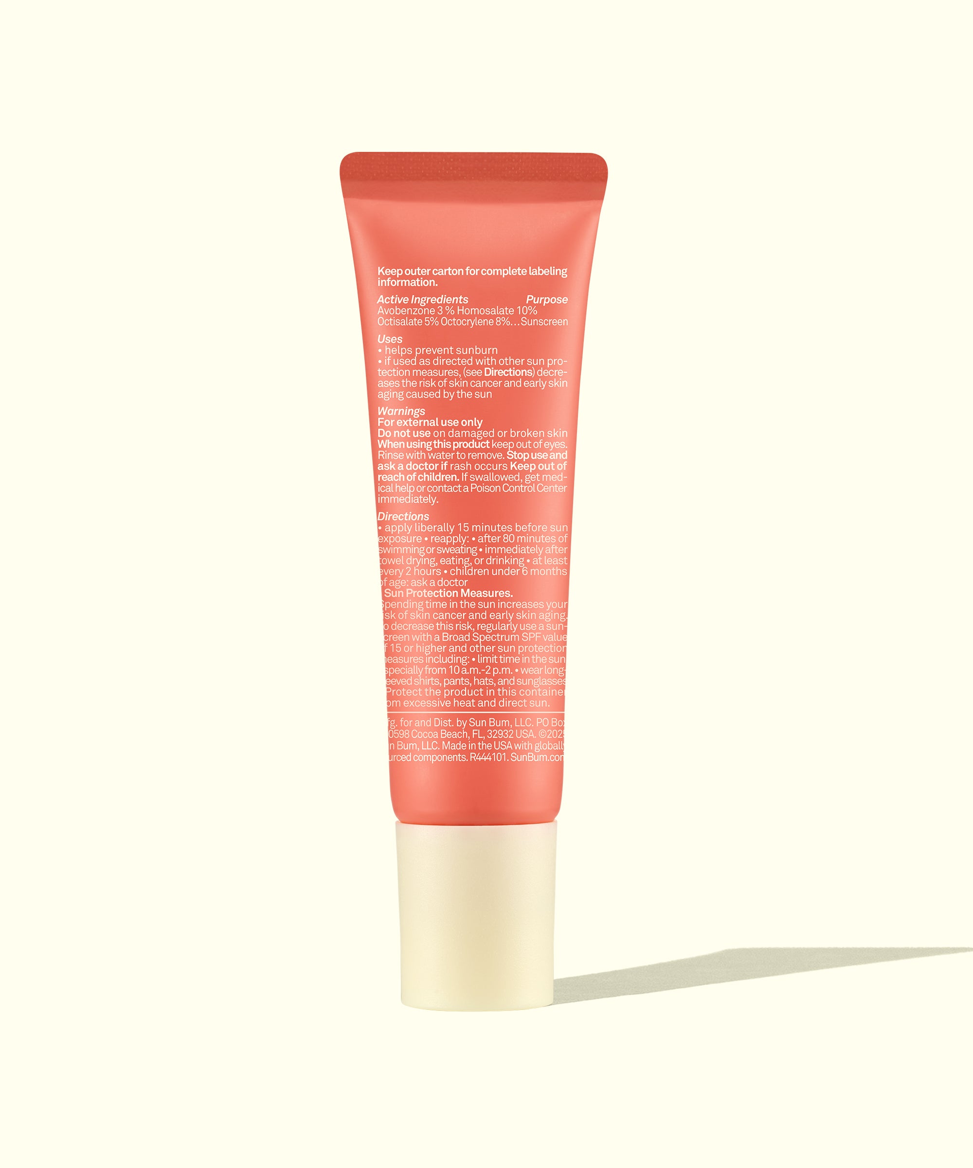 Pink tube of skincare product on a white background