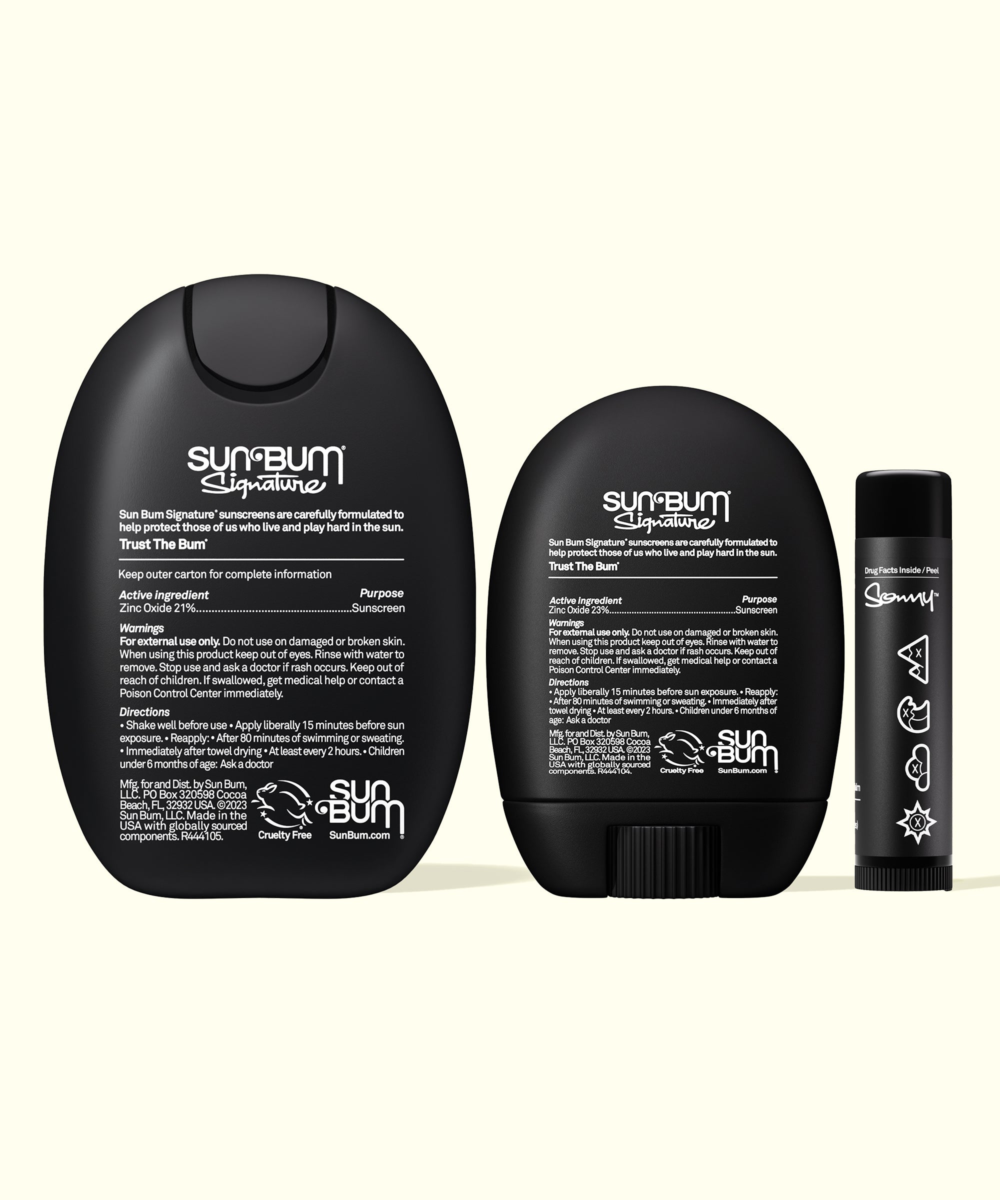 Back views of Sun Bum Signature Mineral Lotion, Face Stick & Lip Balm Bundle showing product details and instructions on black packaging.