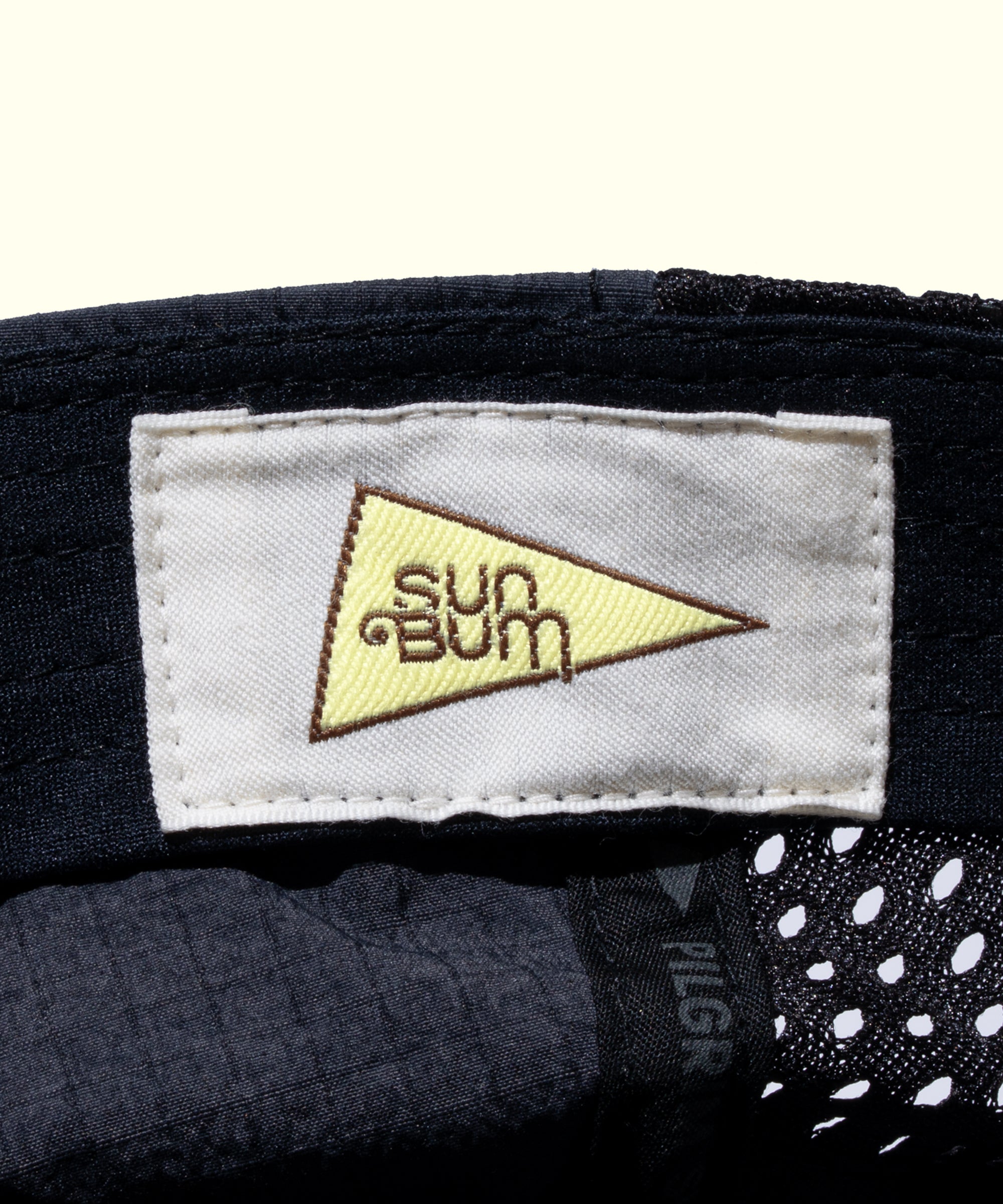 Close-up of a 'Sun Bum' label on a product with a white background