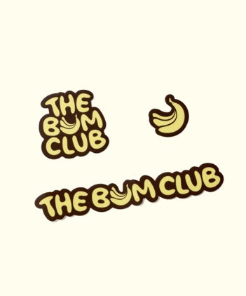 Set of three Sun Bum Bum Club Stickers with playful banana graphics and bold yellow text on a light background.