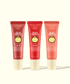 Three tubes of Sun Bum Lip 30 lip balm on a white background