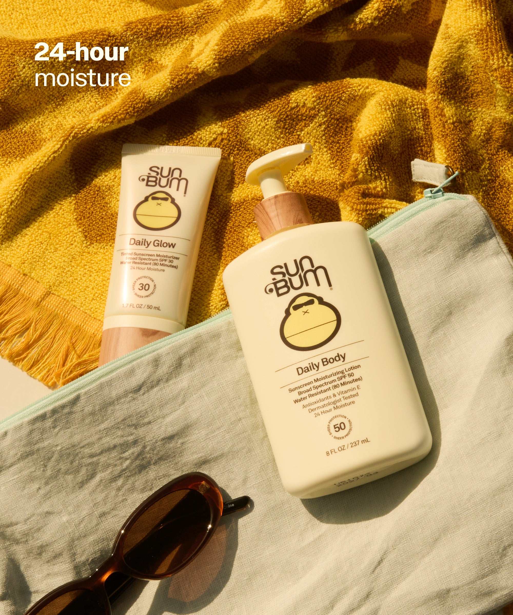 Sun Bum Daily Body + Glow Bundle with SPF lotion and sunscreen on towel with sunglasses in bright sunlight, 24 hour moisture