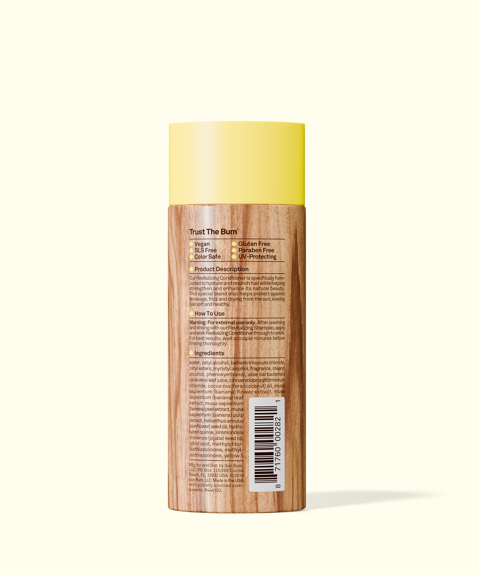 Skincare bottle with yellow cap and wooden body on a white background