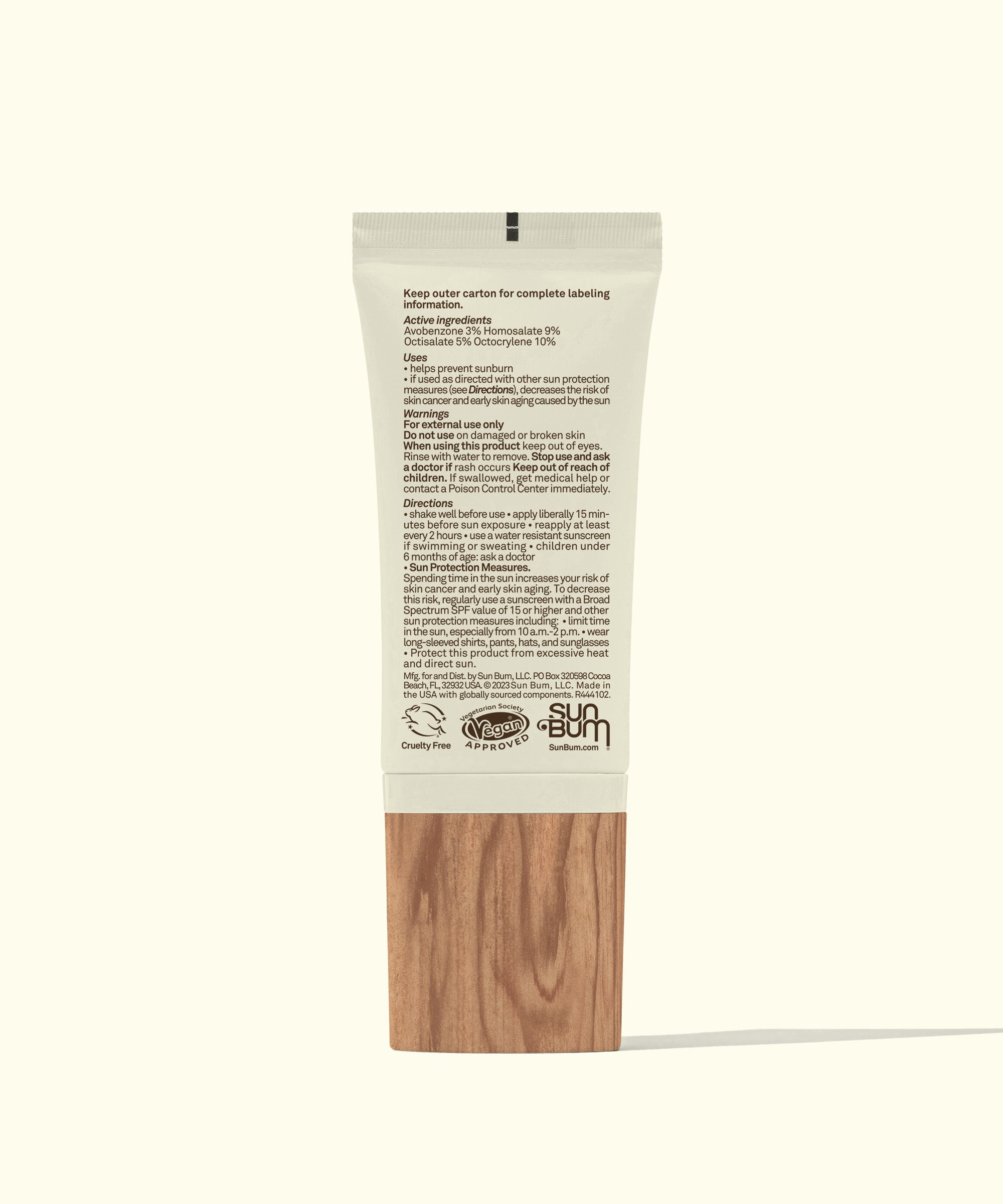 Skincare product packaging with wooden base on a white background