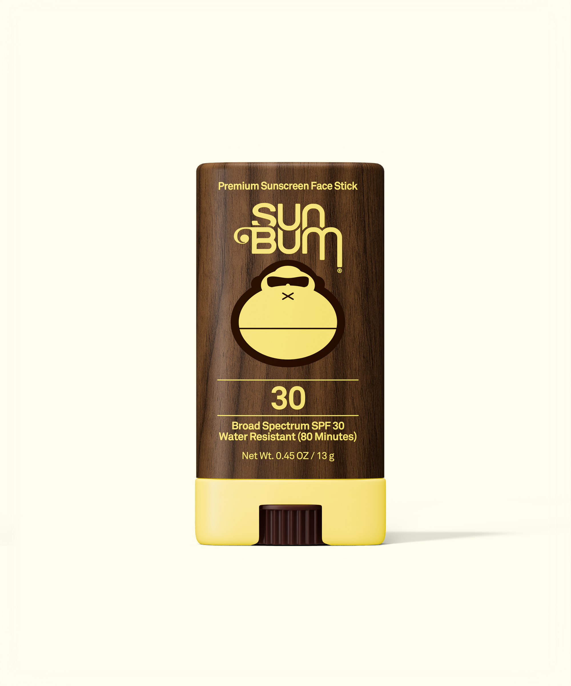 Sun Bum sunscreen stick with brown and yellow design on a white background