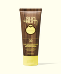 Sun Bum sunscreen tube with wooden design and yellow cap on a white background