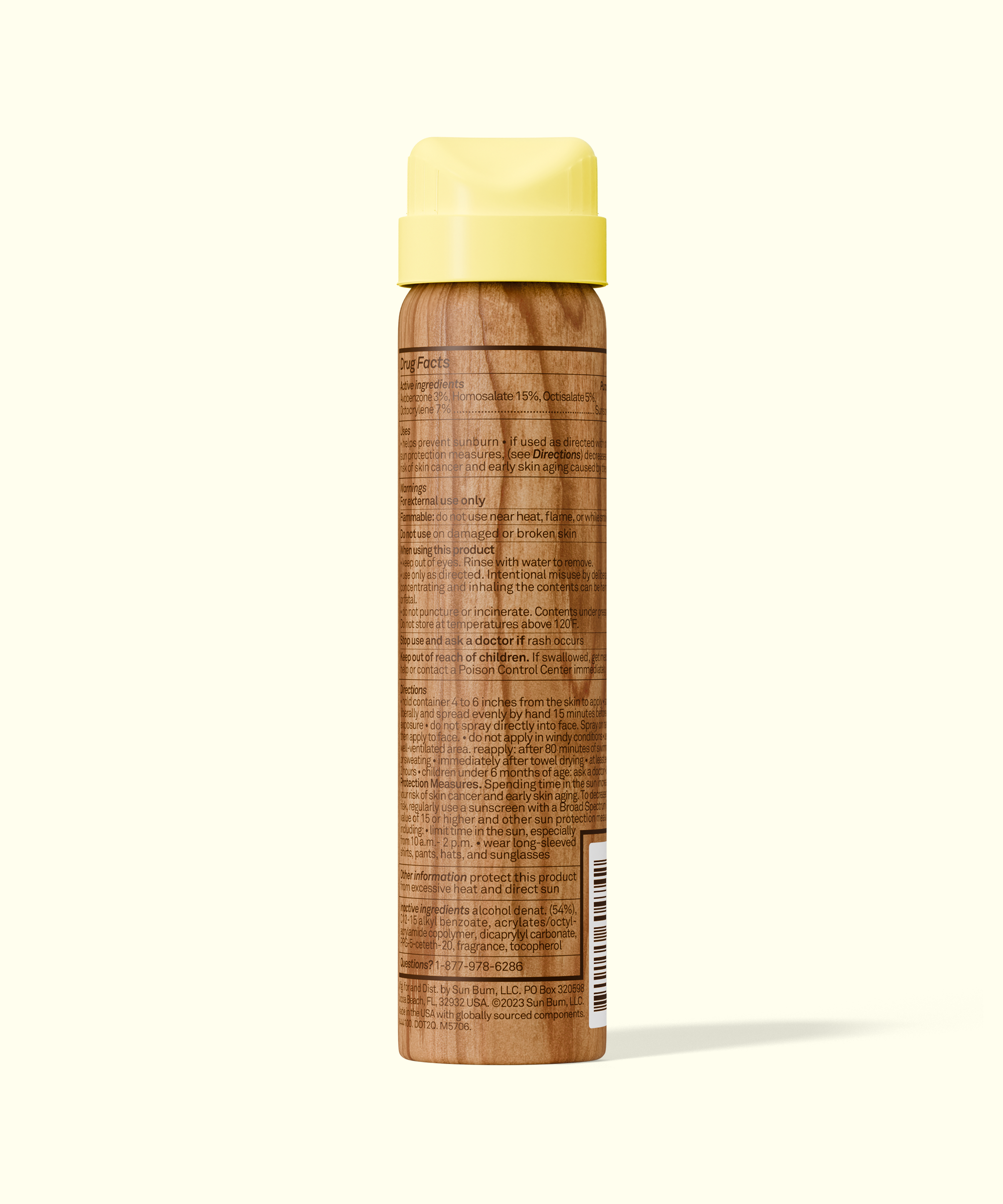 Back view of Sun Bum Original SPF 50 Sunscreen Spray with wood-textured bottle and yellow cap