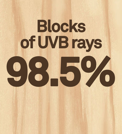 Text indicating blockage of UVB rays on a wooden background