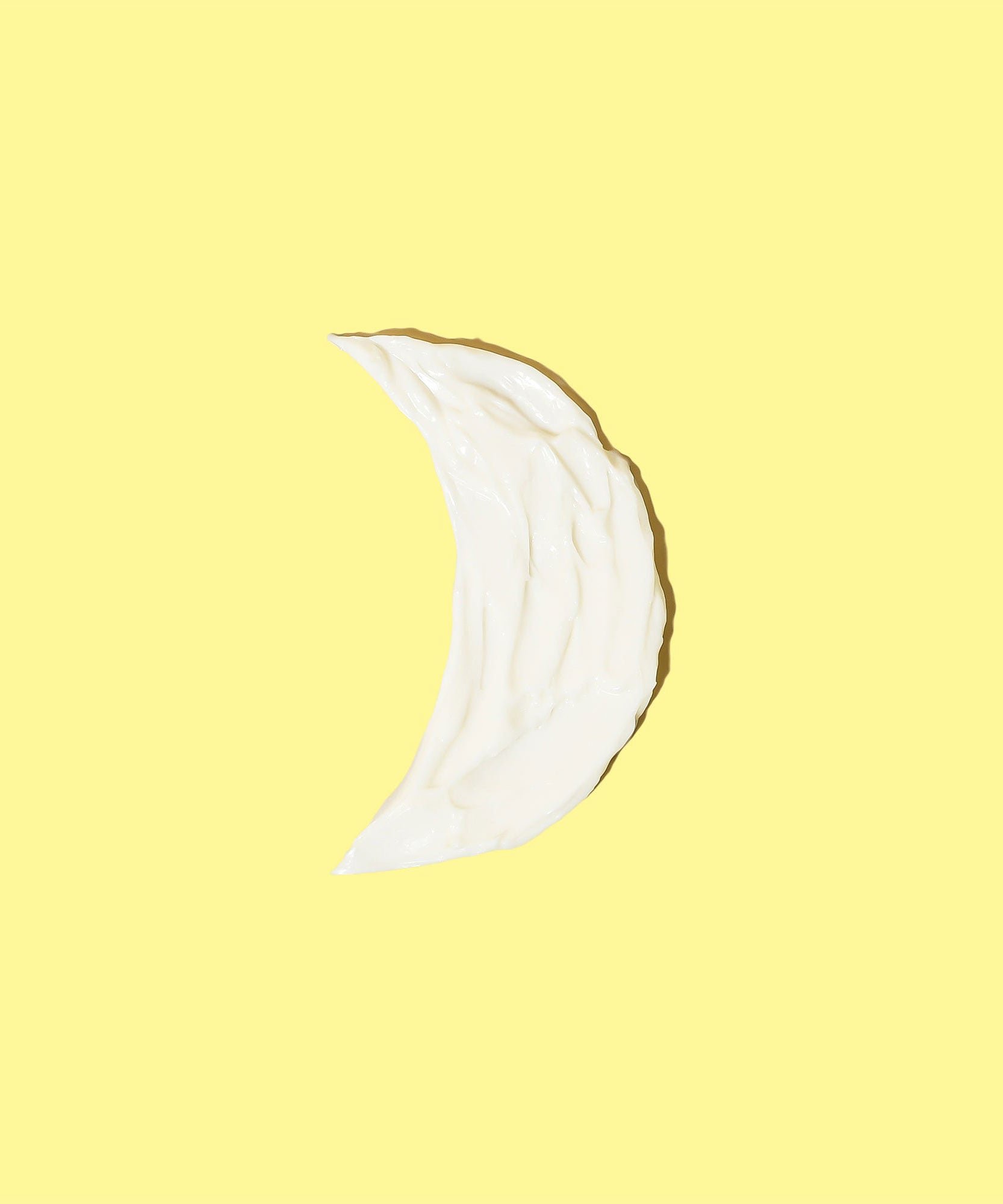 A swatch of Restoring Night Cream in the shape of a crescent moon, highlighting its soothing and nourishing texture for nighttime skin rejuvenation. Sun Bum.