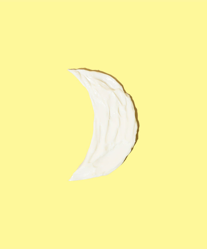 A swatch of Restoring Night Cream in the shape of a crescent moon, highlighting its soothing and nourishing texture for nighttime skin rejuvenation. Sun Bum.