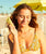 Woman holding a bottle of Original Glow SPF 30 Sunscreen Face Lotion